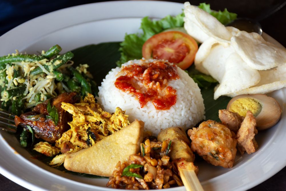 When visiting Bali, one must have a taste of its national dish – the Nasi Campur.